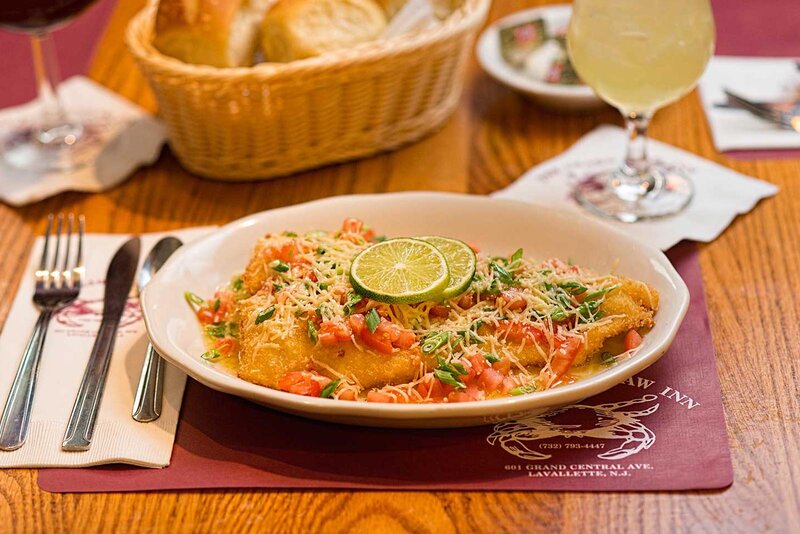 Fried fish entree topped with grated cheese and sliced lime